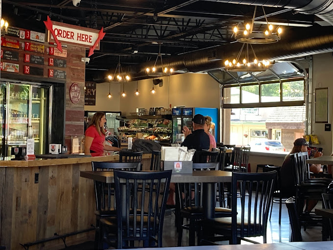 Inside the Balsam Lake Brewery with a couple of customers talking with the beertender at the bar