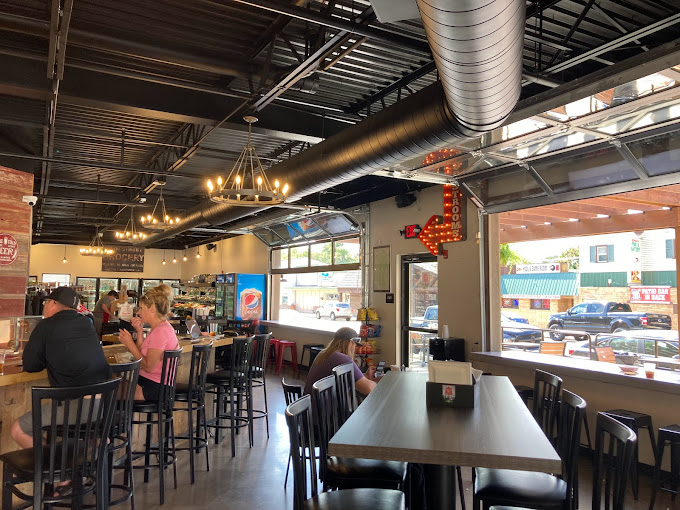 The inside of a restaurant with people sitting at tables.