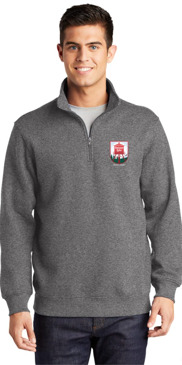 A man wearing a Quarter Zip Sweatshirt Gray with a red crest.
