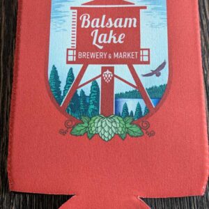 A red Crouler Koozie with "balsam lake brewery & market" logo printed on it.