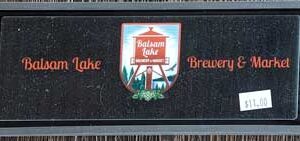A black Rail Mat with an inset displaying a red drink cup and the text "welcome to" above and "Balsam Lake Brewery" below it.
