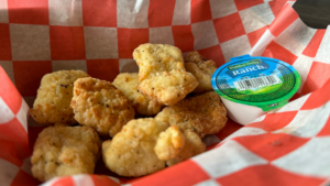 Fried bite-sized food served with a side of ranch dressing.