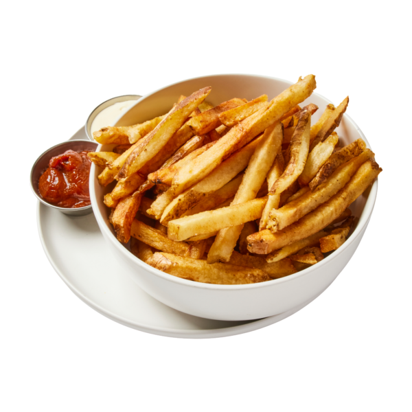 A white bowl filled with Steak Fries is placed on a white plate, accompanied by two small containers of dipping sauces, one with ketchup and the other with creamy white sauce.
